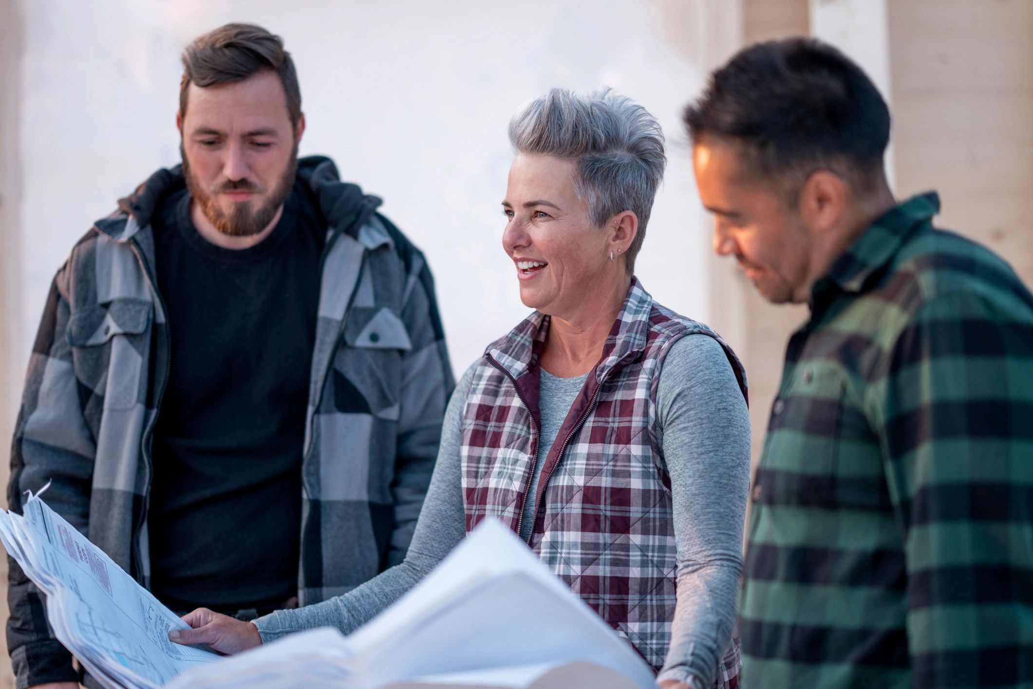 Contractor reviewing blueprints during a home renovation planning discussion